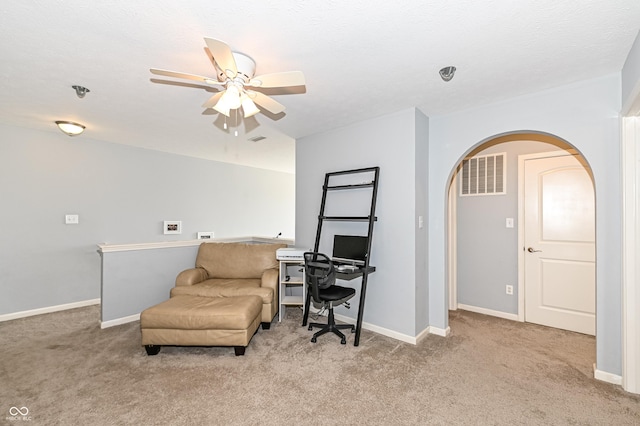 sitting room featuring baseboards, visible vents, arched walkways, and carpet flooring