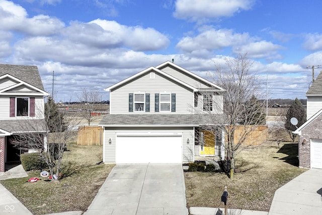 traditional-style home featuring a garage, concrete driveway, and fence