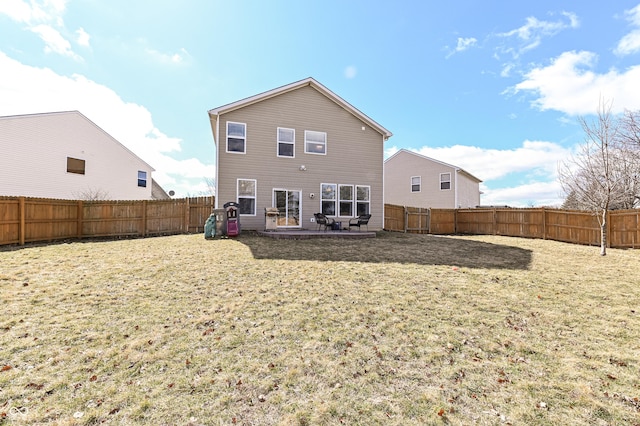 rear view of property with a patio area, a fenced backyard, and a yard