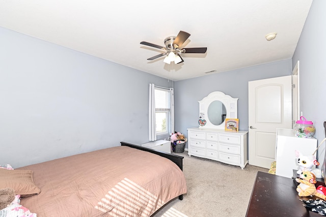 bedroom featuring light carpet, ceiling fan, and visible vents