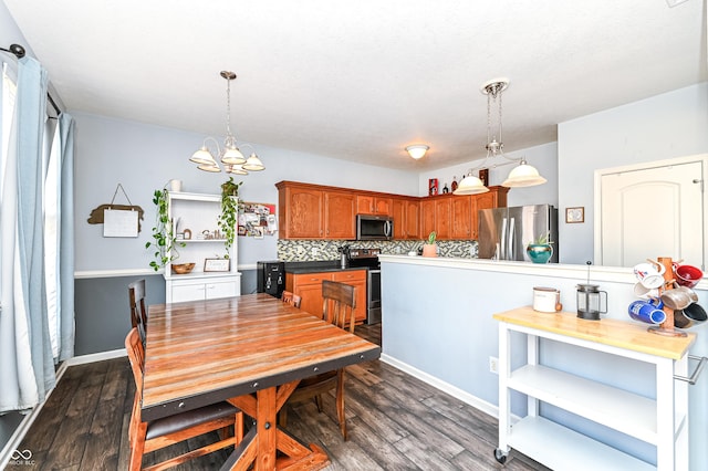 dining area featuring dark wood-style flooring