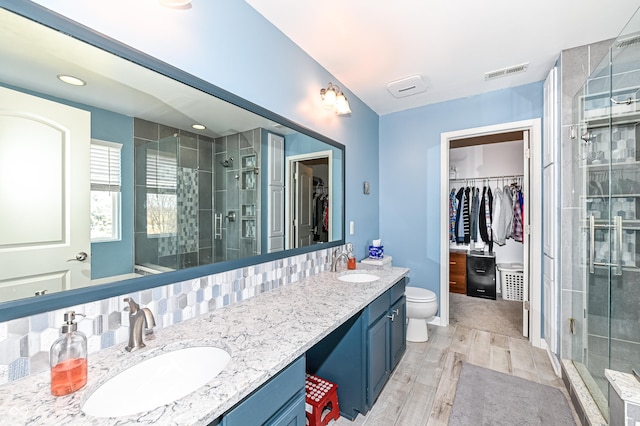 full bath with a shower stall, visible vents, and a sink