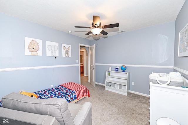 carpeted bedroom featuring ceiling fan, visible vents, arched walkways, and baseboards