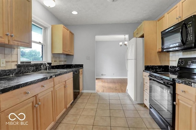 kitchen with light tile patterned floors, light brown cabinets, a sink, decorative backsplash, and black appliances