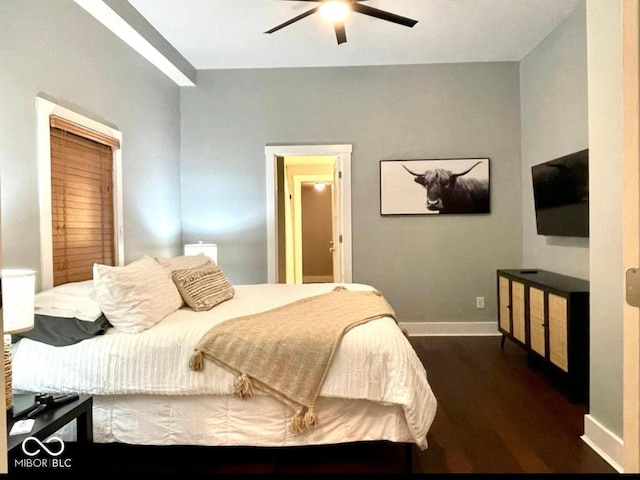 bedroom featuring a ceiling fan, baseboards, and dark wood-style flooring