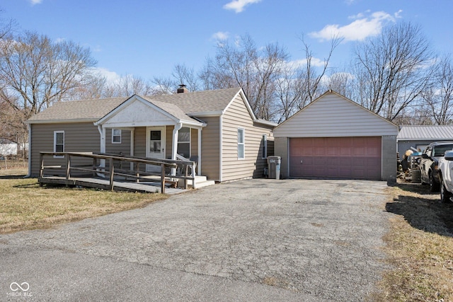 view of front facade with a garage, a chimney, and roof with shingles