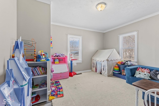 game room with carpet floors, crown molding, baseboards, and a textured ceiling