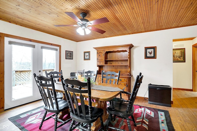 dining room with wooden ceiling, visible vents, baseboards, light wood-style floors, and french doors