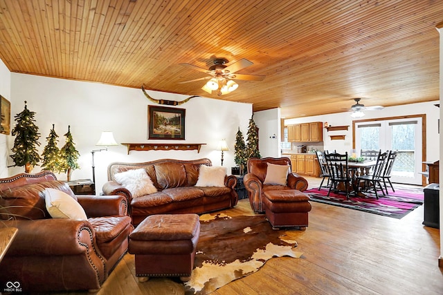 living area featuring wooden ceiling, wood-type flooring, and ceiling fan