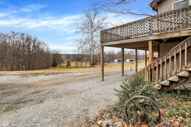 view of yard with stairs and a deck