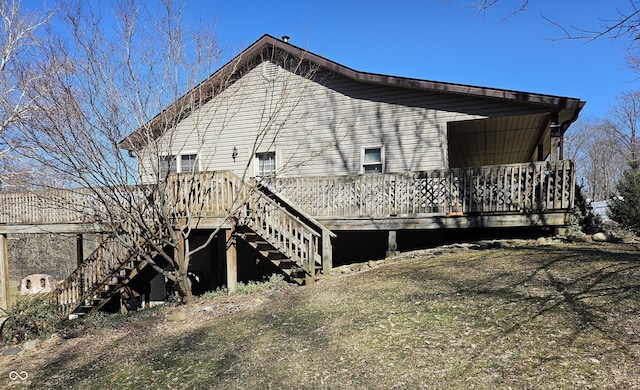 view of property exterior with a deck and stairs