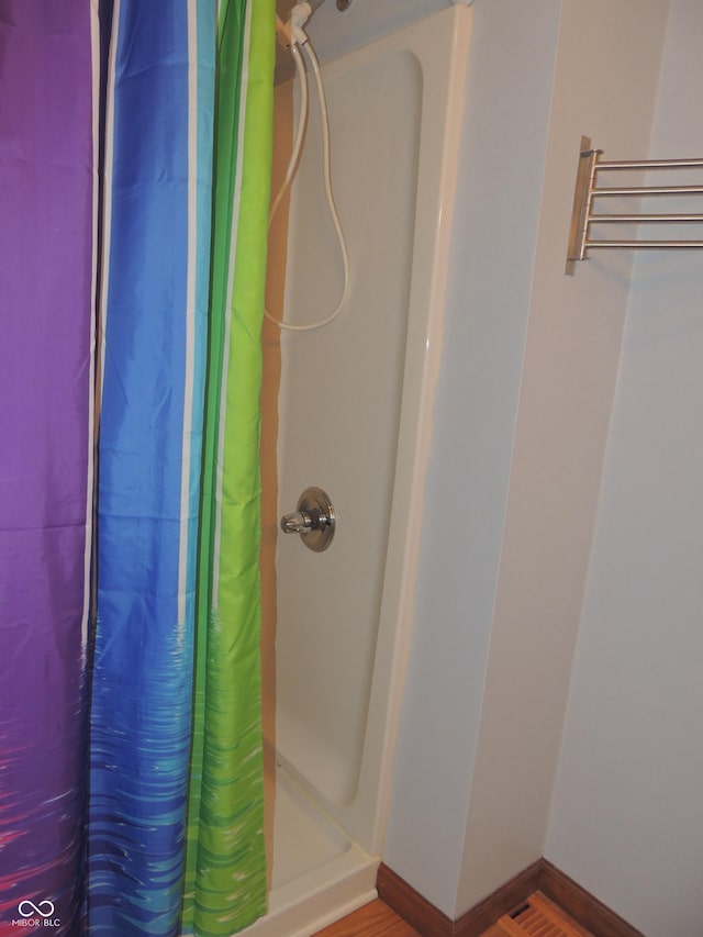 bathroom with curtained shower and baseboards