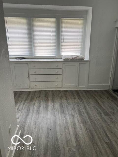 unfurnished room with wood finished floors and baseboards