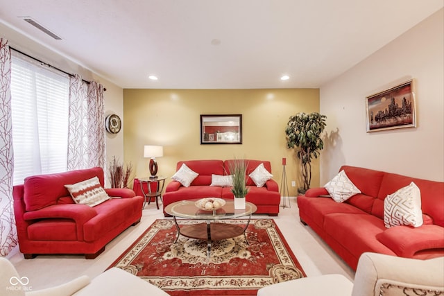 carpeted living room with visible vents and recessed lighting