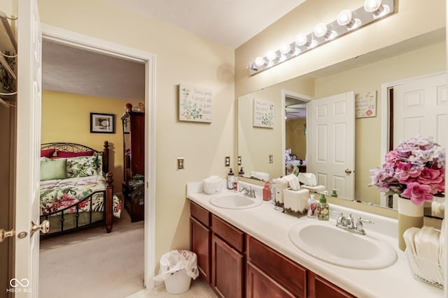 ensuite bathroom with connected bathroom, a sink, and double vanity