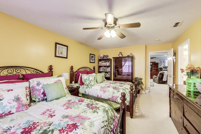 bedroom with a ceiling fan, light colored carpet, and visible vents