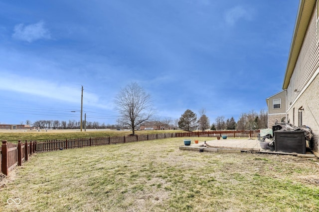 view of yard with a fenced backyard and a rural view