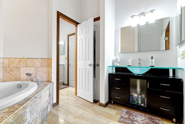 bathroom featuring a garden tub, vanity, and baseboards