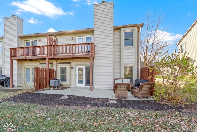 back of house featuring a patio area, fence, a chimney, and central air condition unit