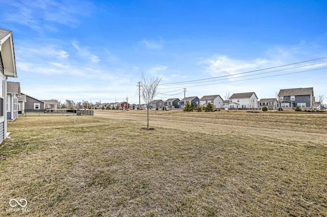 view of yard with fence and a residential view