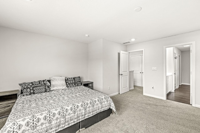 carpeted bedroom featuring visible vents and baseboards