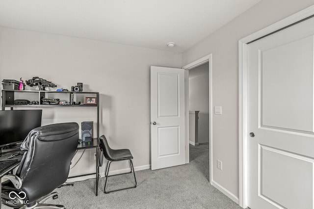 carpeted home office featuring baseboards