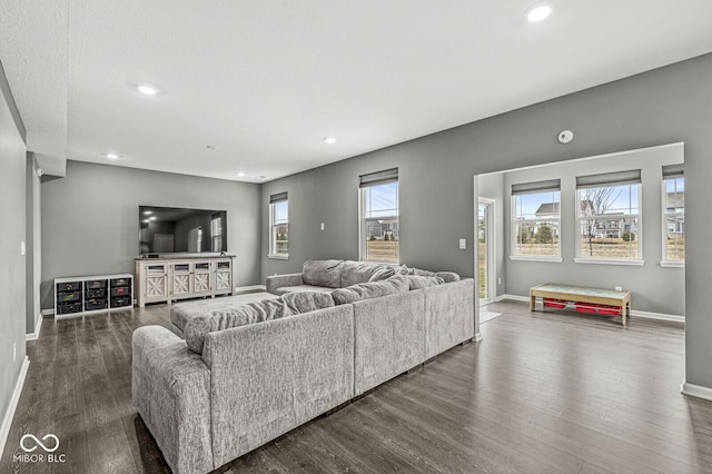 living room with recessed lighting, dark wood finished floors, and baseboards