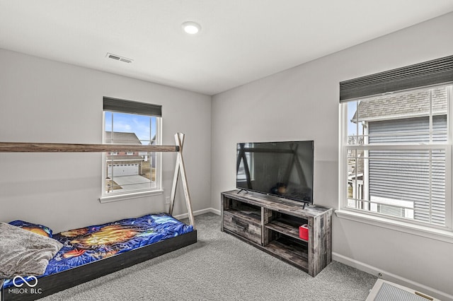 carpeted bedroom with visible vents and baseboards