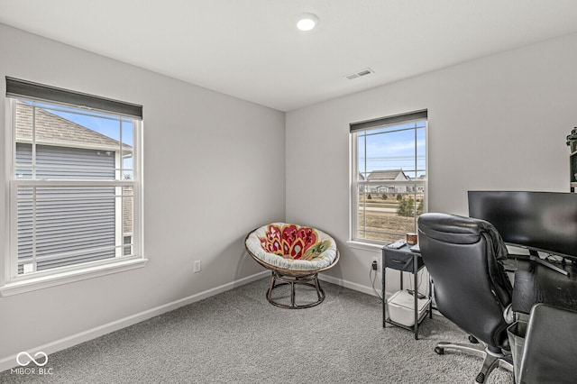 office space featuring baseboards, visible vents, and carpet flooring