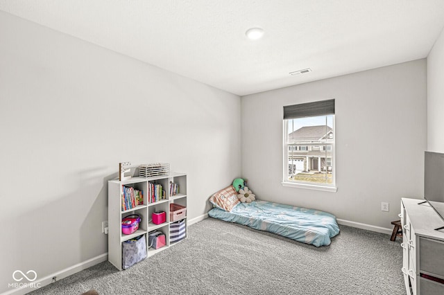 carpeted bedroom featuring visible vents and baseboards