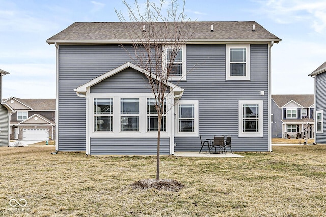 rear view of property with a yard and a patio