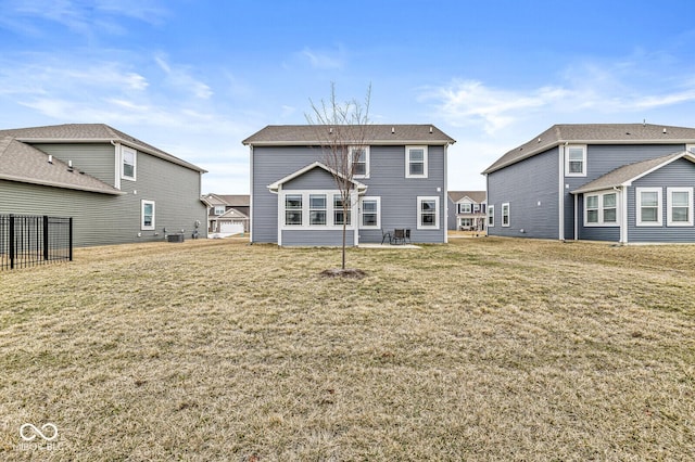 rear view of house with a yard