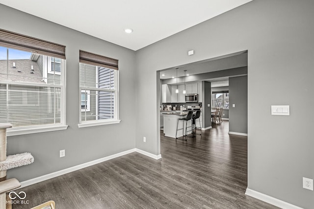 interior space featuring dark wood-style flooring, recessed lighting, and baseboards