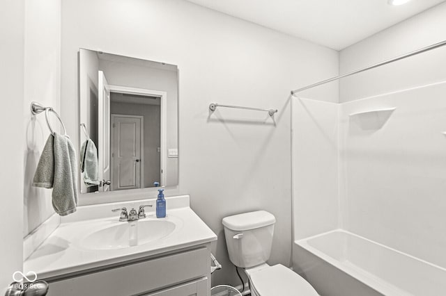 bathroom featuring toilet, bathing tub / shower combination, and vanity