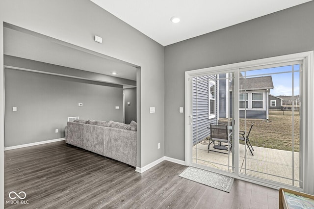 doorway to outside with recessed lighting, wood finished floors, and baseboards