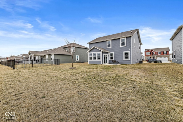 back of house featuring fence, a patio, and a yard