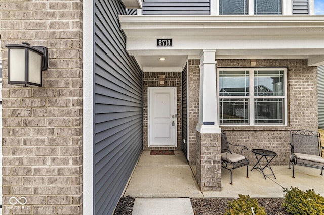 property entrance with brick siding