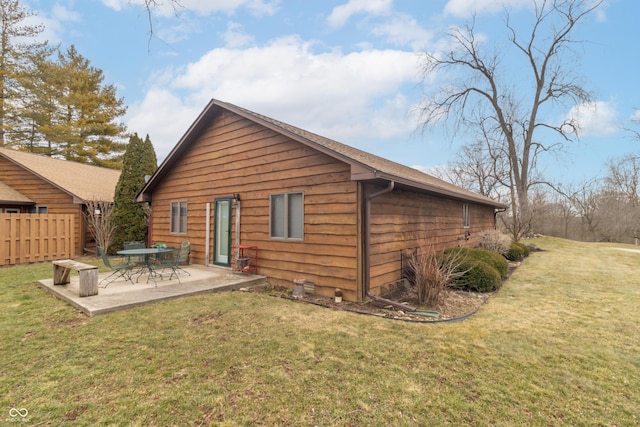 back of house featuring a patio area, fence, and a lawn