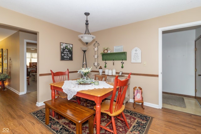 dining room with baseboards and wood finished floors