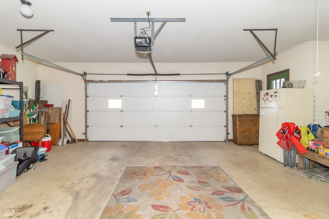 garage with a garage door opener and freestanding refrigerator