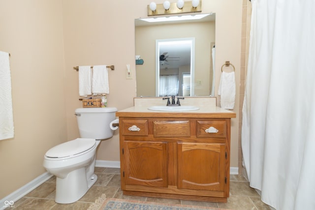 bathroom featuring toilet, a ceiling fan, a shower with shower curtain, baseboards, and vanity