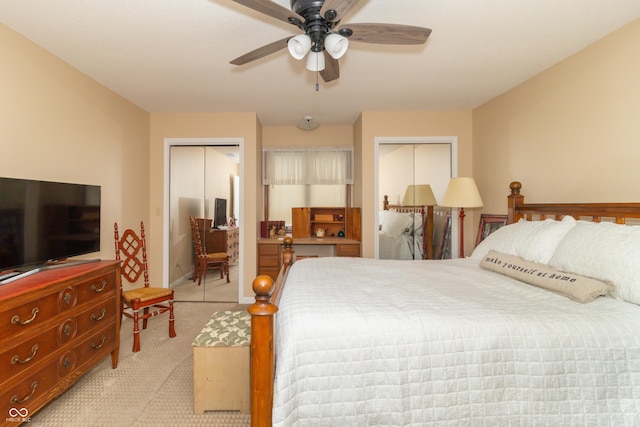 carpeted bedroom with multiple closets and ceiling fan