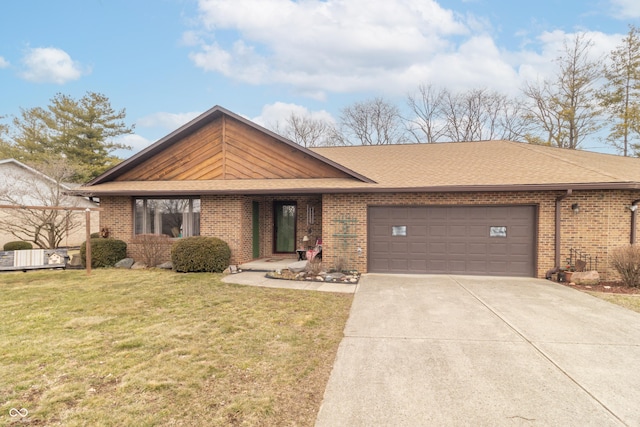 view of front of home with a front lawn, an attached garage, brick siding, and concrete driveway