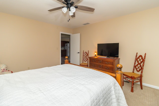 bedroom with a ceiling fan, baseboards, visible vents, and light carpet