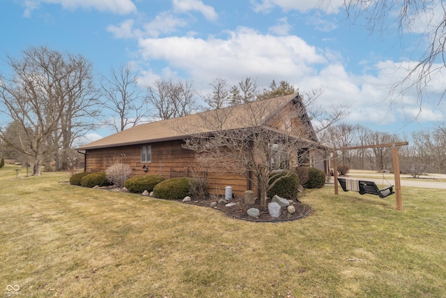 view of side of home featuring a yard