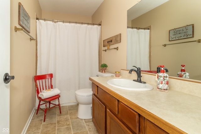 bathroom featuring toilet and vanity