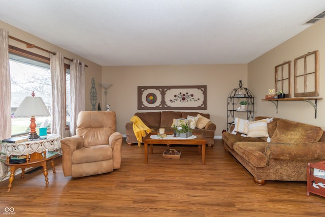 living room featuring visible vents and wood finished floors