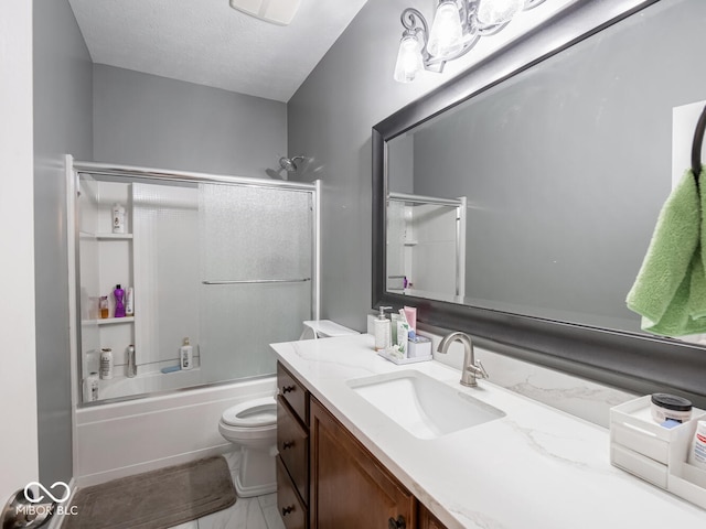 bathroom featuring a textured ceiling, vanity, toilet, and enclosed tub / shower combo