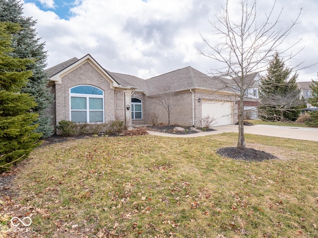 ranch-style home with a garage, a front yard, concrete driveway, and brick siding