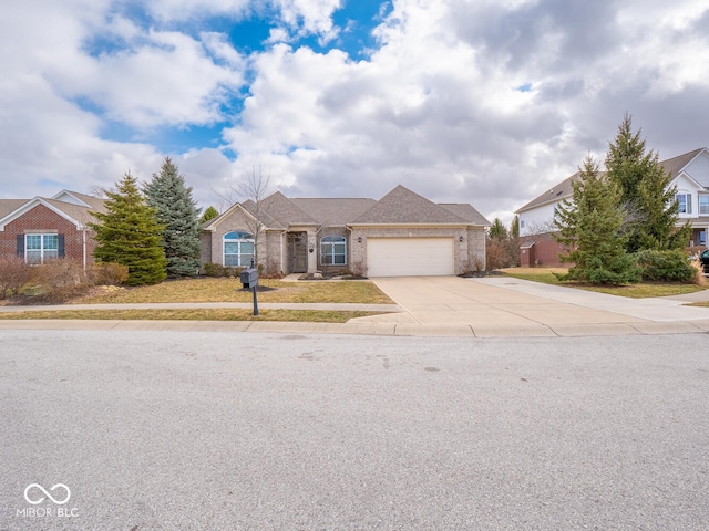 view of front of home featuring an attached garage, concrete driveway, and brick siding